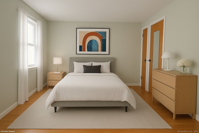 bedroom with baseboards and light wood-type flooring