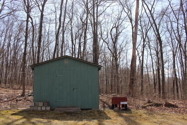 view of shed featuring a forest view