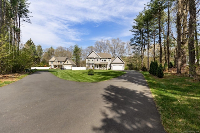 view of front facade featuring a front lawn and aphalt driveway
