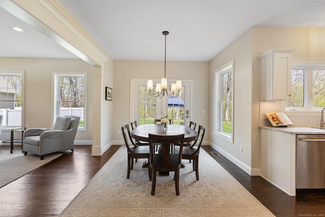 dining room with baseboards, a notable chandelier, dark wood finished floors, and visible vents