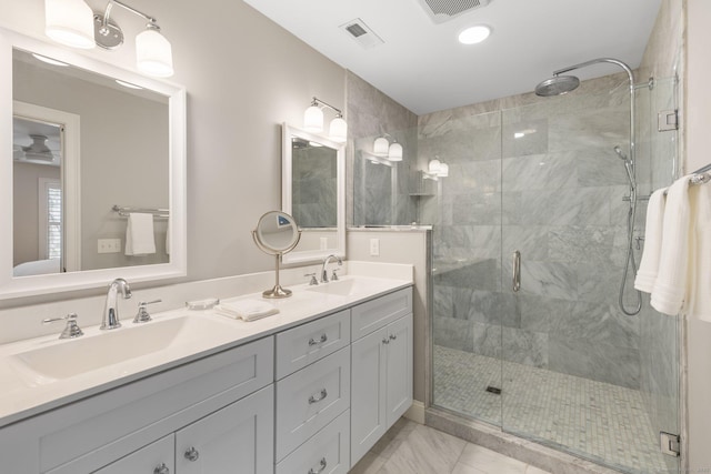 full bathroom with visible vents, a shower stall, and a sink