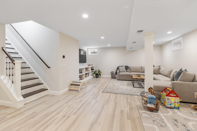 living room featuring visible vents, stairs, wood finished floors, baseboards, and recessed lighting