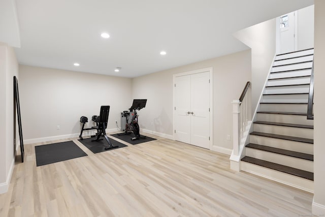 exercise room featuring baseboards, recessed lighting, and wood finished floors
