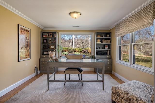 home office featuring ornamental molding, visible vents, wood finished floors, and baseboards