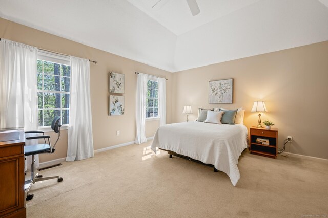bedroom featuring light carpet, baseboards, a desk, ceiling fan, and vaulted ceiling