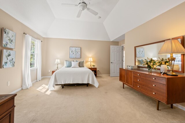 bedroom featuring light carpet, baseboards, lofted ceiling, and a ceiling fan