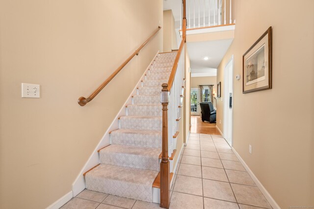 stairs featuring tile patterned flooring and baseboards
