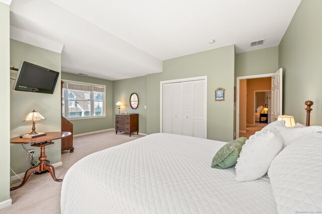 bedroom with carpet flooring, baseboards, and a closet