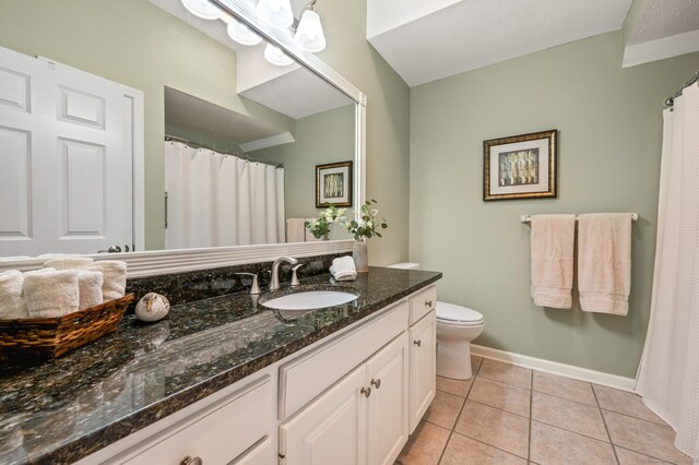 full bathroom featuring vanity, tile patterned floors, toilet, and baseboards
