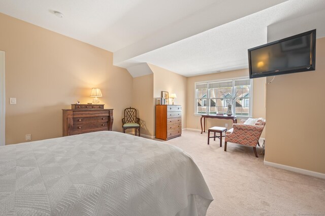carpeted bedroom featuring baseboards
