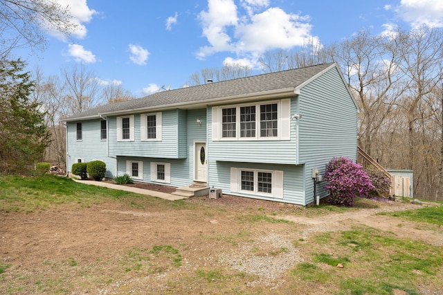 back of property featuring a shingled roof