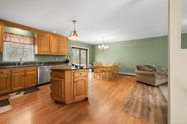 kitchen with a sink, dark countertops, light wood-type flooring, a baseboard radiator, and dishwasher