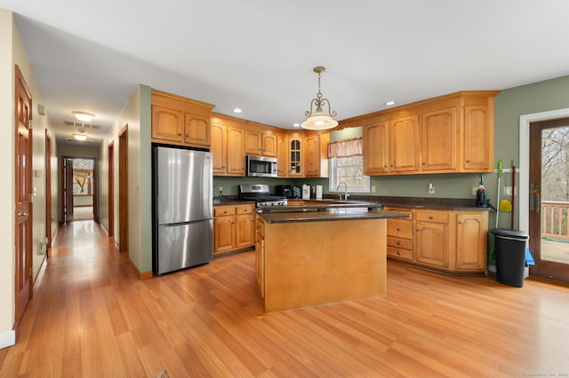 kitchen featuring visible vents, light wood finished floors, appliances with stainless steel finishes, and dark countertops