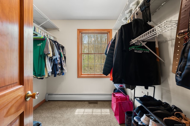 walk in closet with carpet and a baseboard heating unit