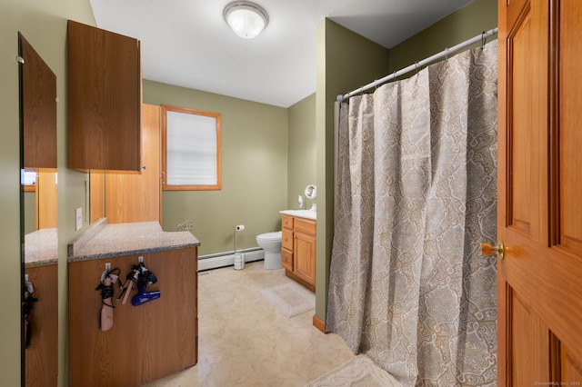 bathroom with vanity, toilet, baseboards, tile patterned floors, and a baseboard radiator