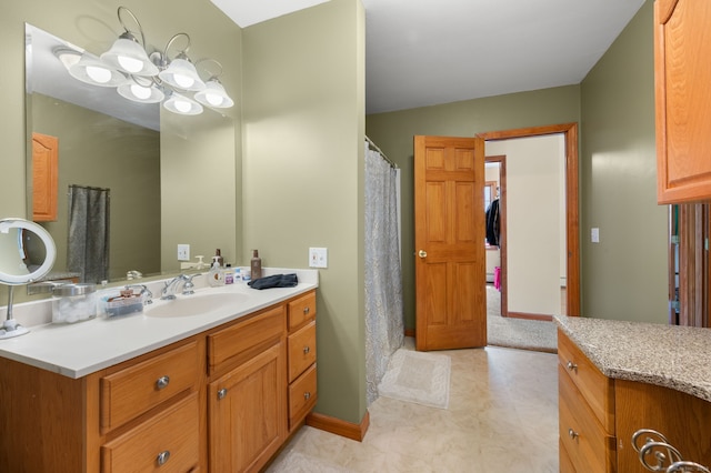 full bath with vanity, baseboards, a shower with shower curtain, tile patterned floors, and a notable chandelier