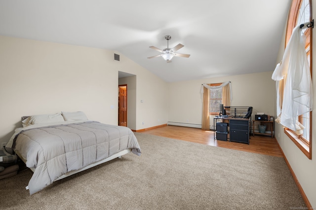 bedroom featuring visible vents, carpet floors, baseboards, lofted ceiling, and a baseboard heating unit
