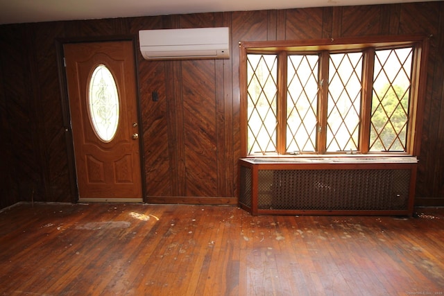 44 Old Plains Rd, Windham, CT 06226 - foyer entrance with radiator, plenty of natural light, wood-type flooring, and a wall mounted AC