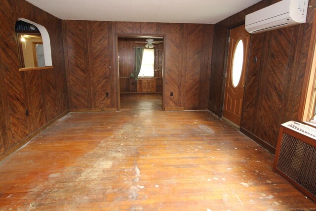 44 Old Plains Rd, Windham, CT 06226 - foyer featuring hardwood / wood-style flooring, wooden walls, and a wall mounted AC