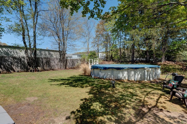 view of yard with a covered pool