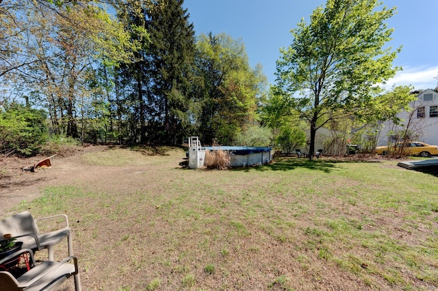 view of yard featuring a covered pool