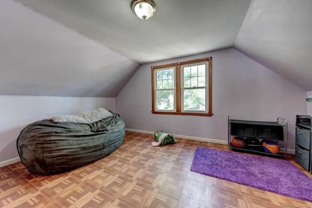 additional living space featuring baseboards and vaulted ceiling