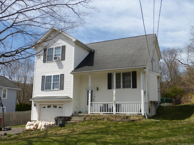 56 Hoadley St, Naugatuck, CT 06770 - view of front facade featuring covered porch, fence, a garage, roof with shingles, and a front yard