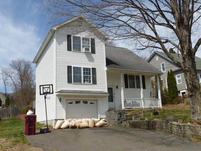 56 Hoadley St, Naugatuck, CT 06770 - view of front of home with aphalt driveway, a porch, and an attached garage