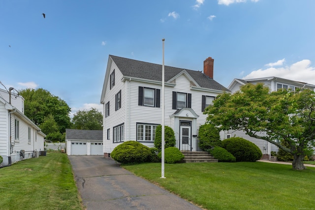 706 Ocean Ave, West Haven, CT 06516 - traditional home featuring an outbuilding, a detached garage, a front lawn, and a chimney