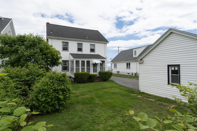 706 Ocean Ave, West Haven, CT 06516 - back of property with a lawn and a shingled roof