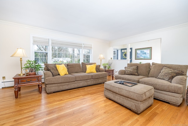 living area featuring crown molding, a baseboard heating unit, and light wood-type flooring