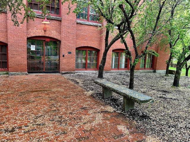 property entrance featuring brick siding