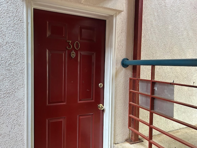 doorway to property with stucco siding