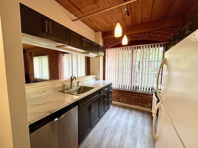 kitchen with freestanding refrigerator, stainless steel dishwasher, light wood finished floors, a sink, and light countertops