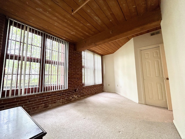 carpeted spare room featuring brick wall, wood ceiling, visible vents, and a wealth of natural light