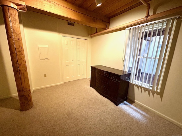 hallway featuring wooden ceiling, visible vents, baseboards, and carpet floors