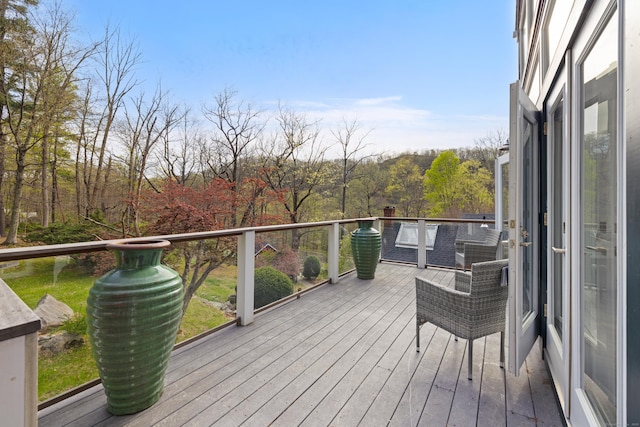 wooden deck with a forest view