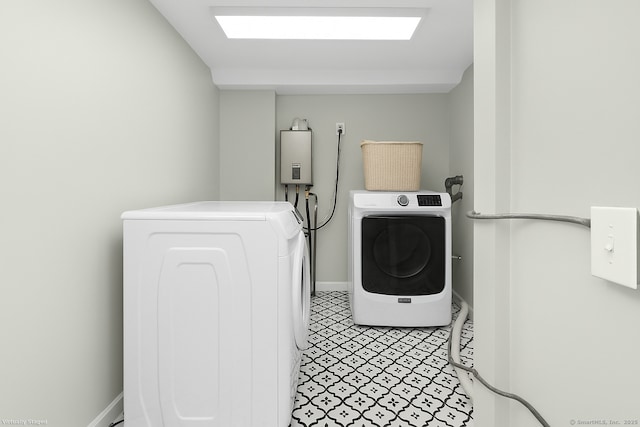clothes washing area with washing machine and clothes dryer, laundry area, tankless water heater, and baseboards