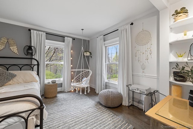 bedroom with crown molding and wood finished floors