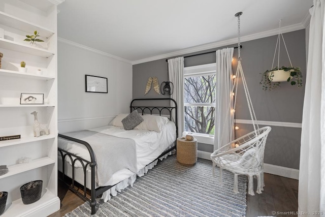 bedroom featuring crown molding and wood finished floors