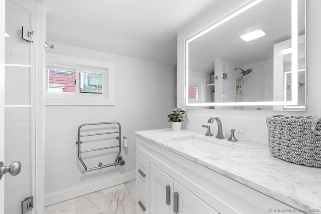 bathroom with vanity, baseboards, marble finish floor, and a stall shower