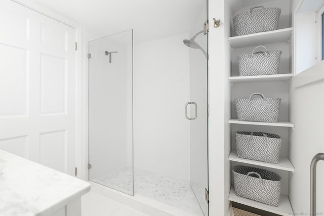 bathroom featuring tile patterned flooring and a stall shower