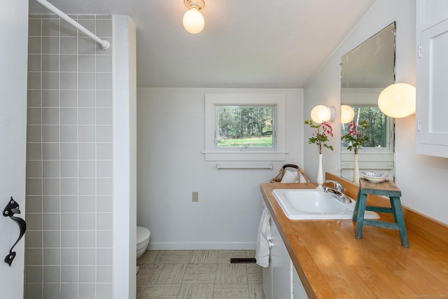 full bath with toilet, baseboards, plenty of natural light, and vanity