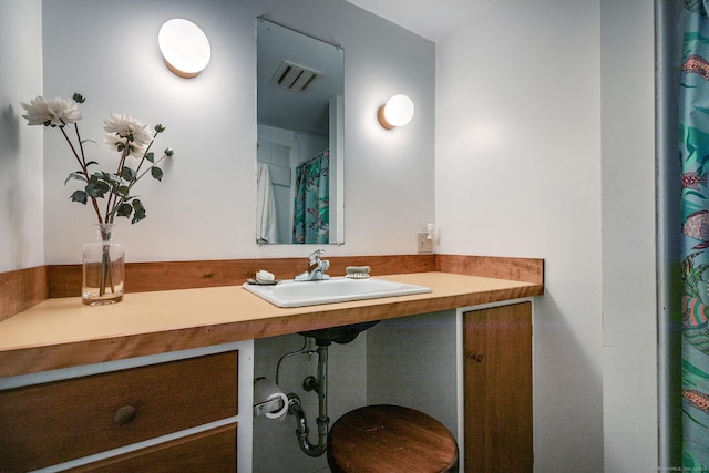 full bath with a sink and visible vents