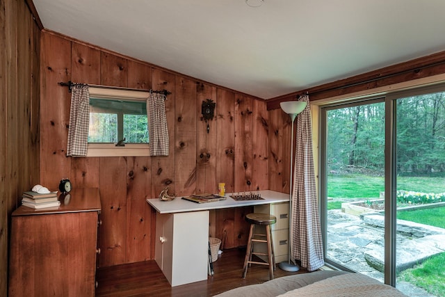 interior space featuring wooden walls, wood finished floors, and lofted ceiling