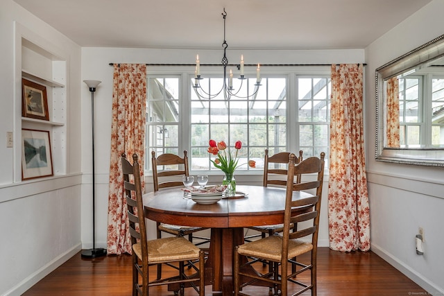 dining room with baseboards, dark wood-style floors, and a notable chandelier