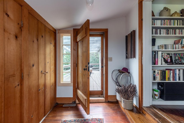 entryway featuring wood finished floors and lofted ceiling