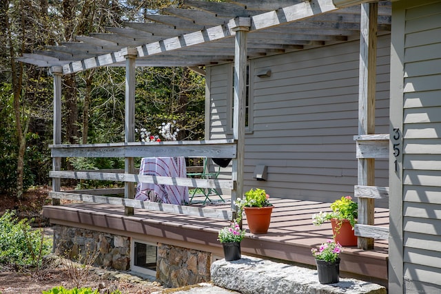 wooden deck featuring a pergola
