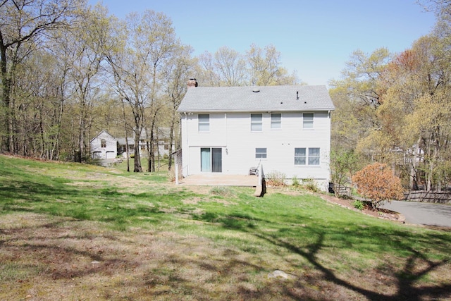 back of property with a lawn, a patio, and a chimney