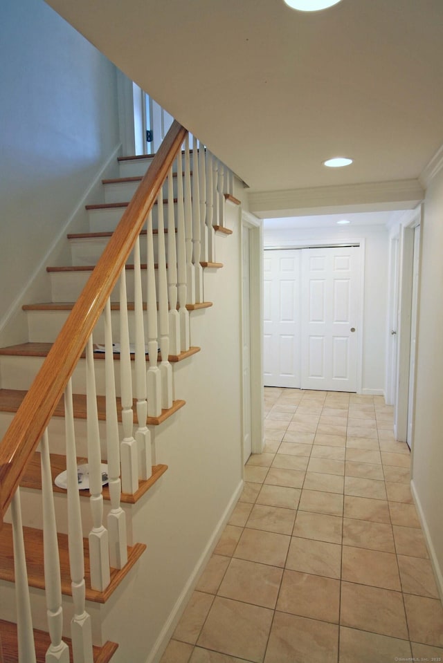 hallway featuring stairway, light tile patterned floors, baseboards, and recessed lighting